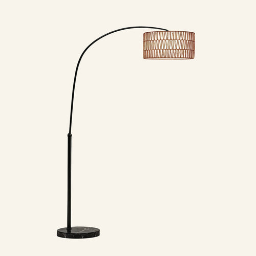 Arc floor lamp with slim black metal arm curving from a round marble base, holding a woven rattan drum shade overhead.