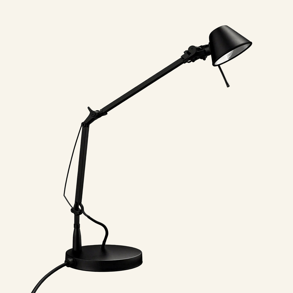 Matte black version of the articulated task lamp showing pivoting joints, cable-tensioned arm, and round weighted base