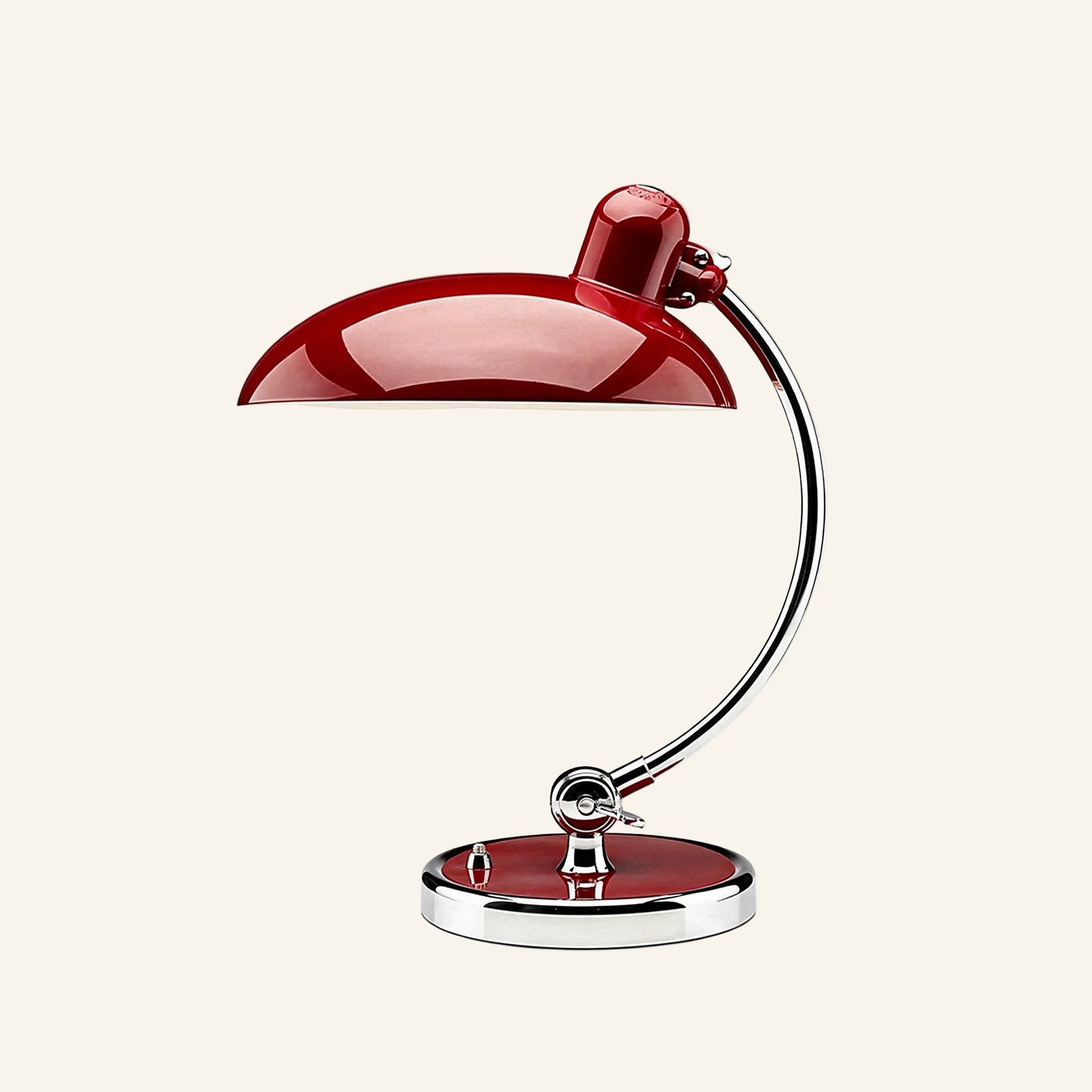 Oxblood-red lacquered dome shade and matching base accent paired with a polished chrome arm, Bauhaus desk lamp on neutral backdrop.