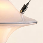 Close-up of glossy opal glass shade meeting polished chrome cable fitting, revealing the rolled saucer rim and subtle pearlescent surface