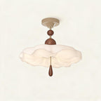 Ruffled cream acrylic semi-flush ceiling light with stacked walnut beads and teardrop pull, mounted on a cream canopy against neutral background.