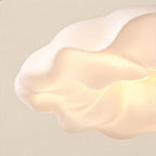 Close-up of the softly rippled cream acrylic shade glowing warmly from within, showing organic wabi-sabi curves and matte finish.