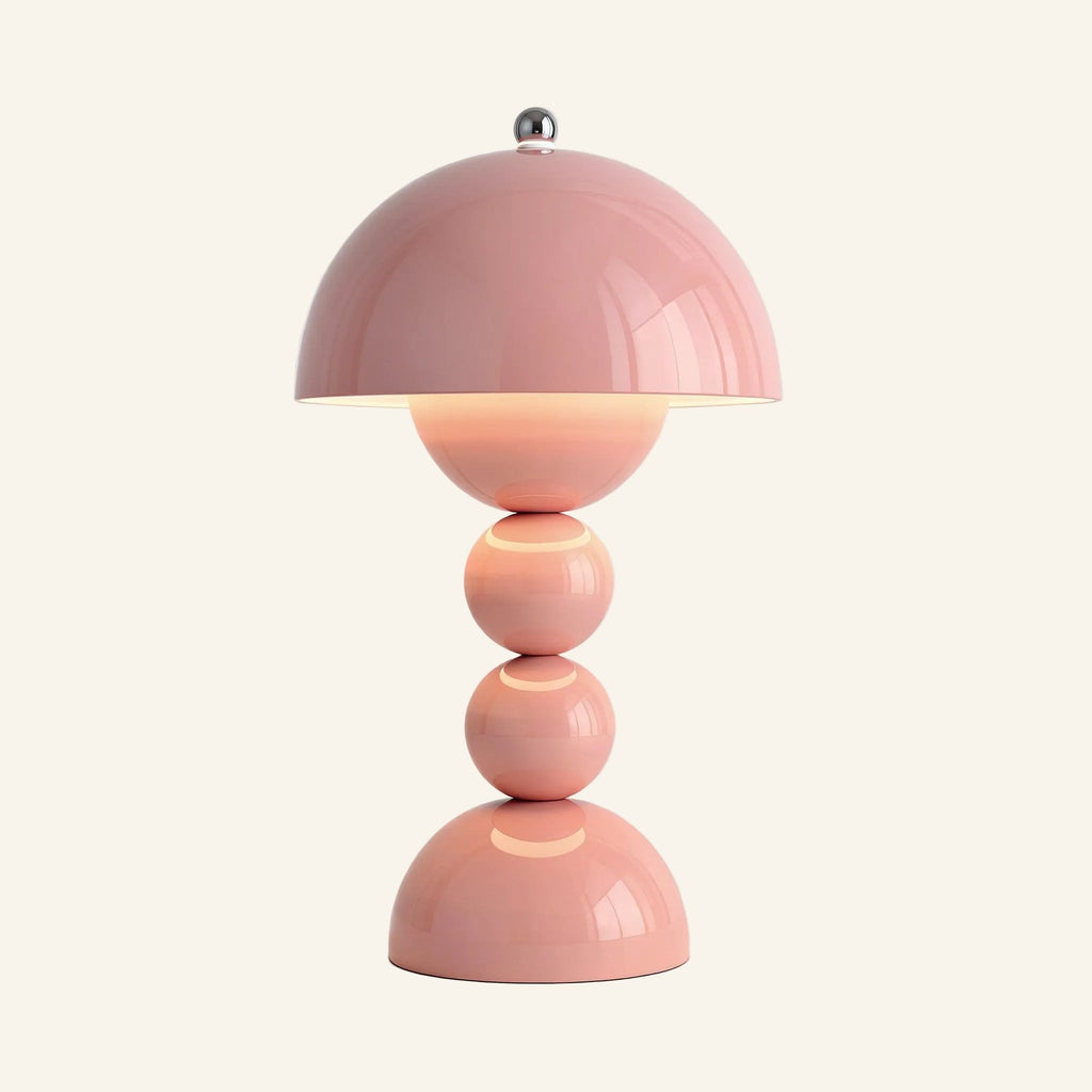 Blush pink version of the cordless mushroom lamp glowing softly, stacked spheres and domed base in matte-gloss ABS on cream backdrop