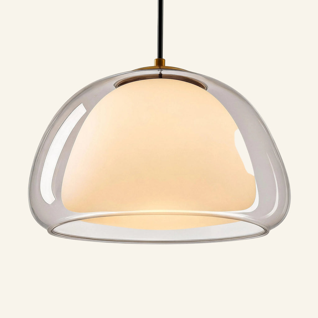 Close-up of layered glass shade showing clear bell wrapping a glowing opal diffuser, highlighting the soft halo effect