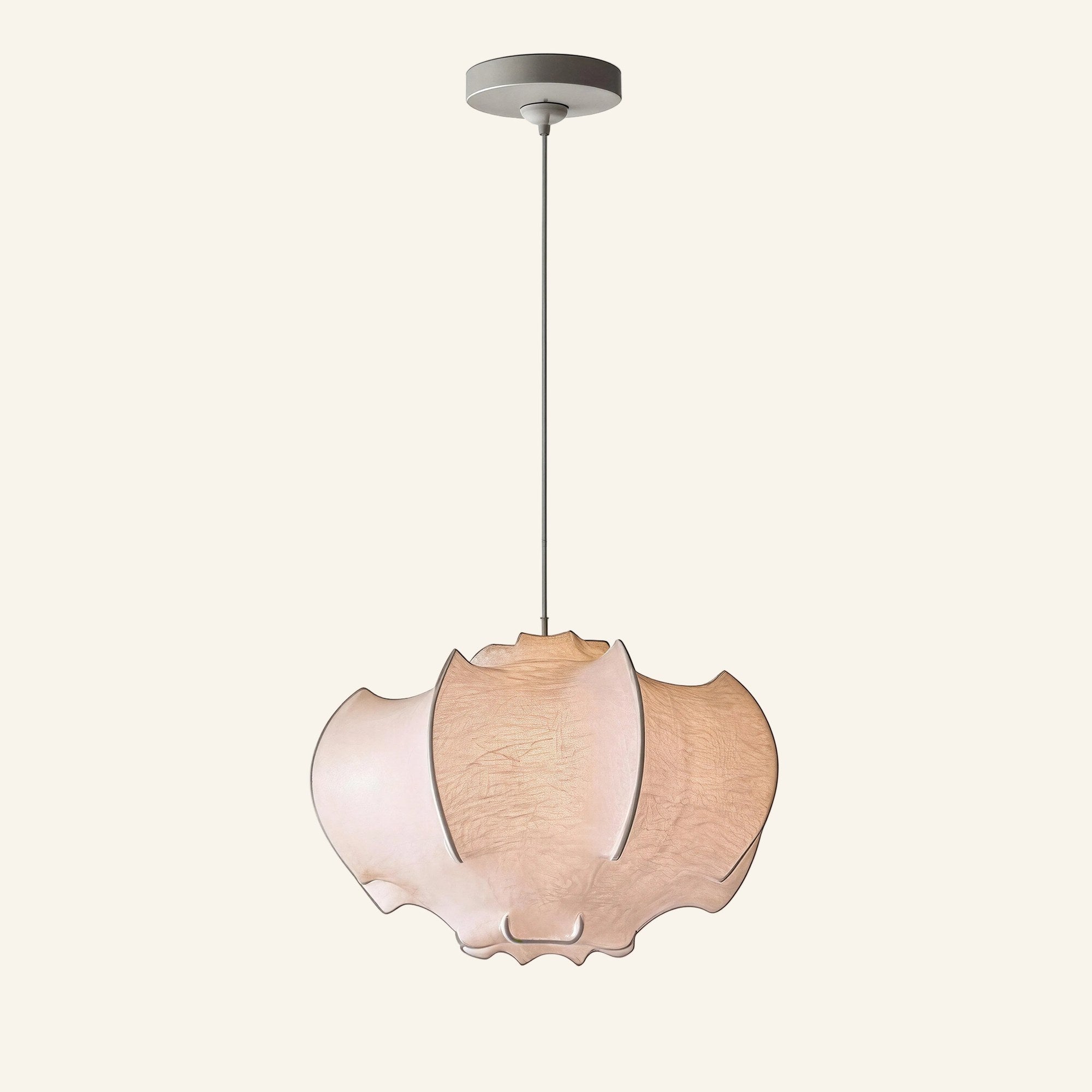Cocoon pendant lamp with overlapping faux-silk petals stretched across an iron frame, hanging from a slim cord on a cream studio background