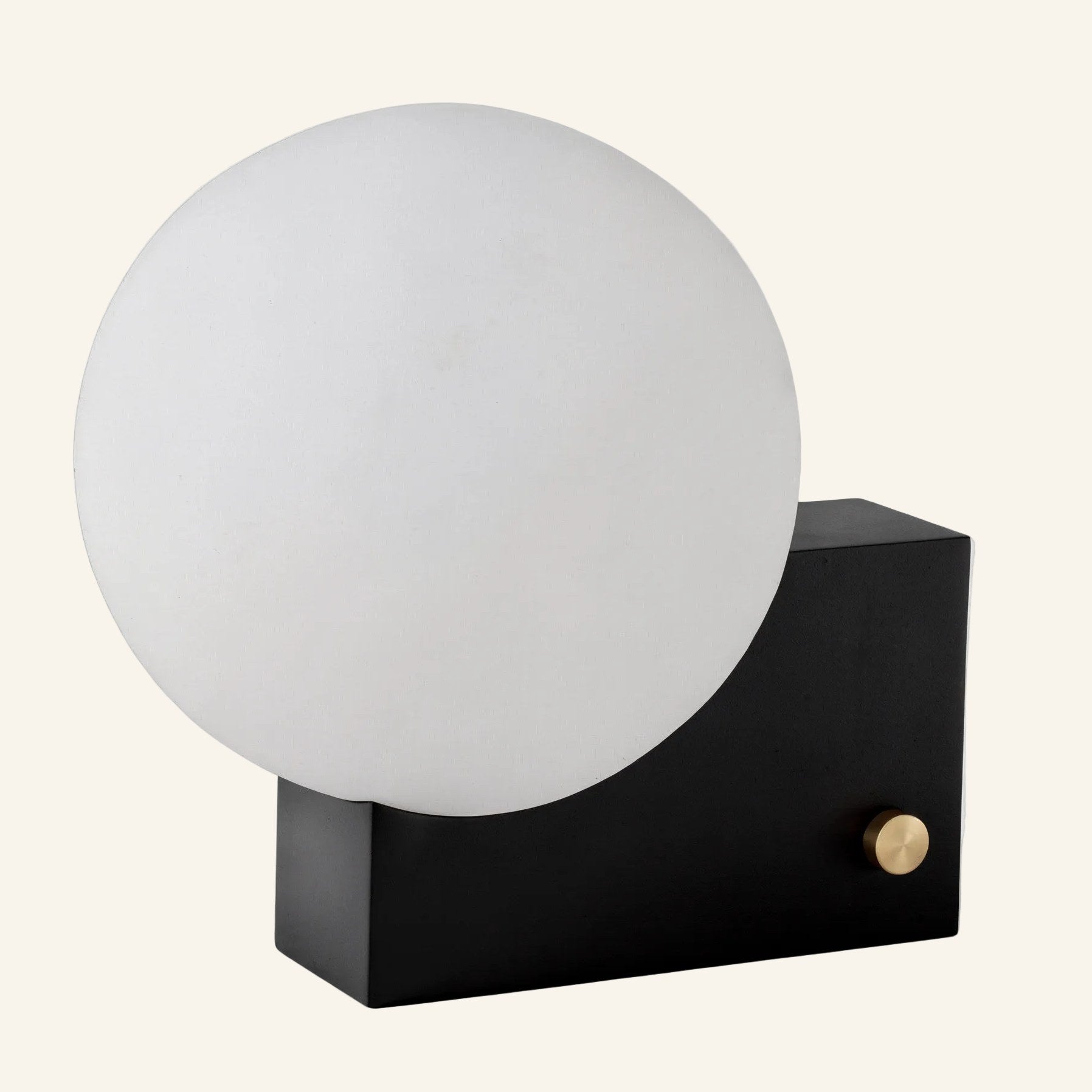 Side angle in black-base finish highlighting the bauhaus contrast between matte cube housing, brass dimmer, and round glass shade.