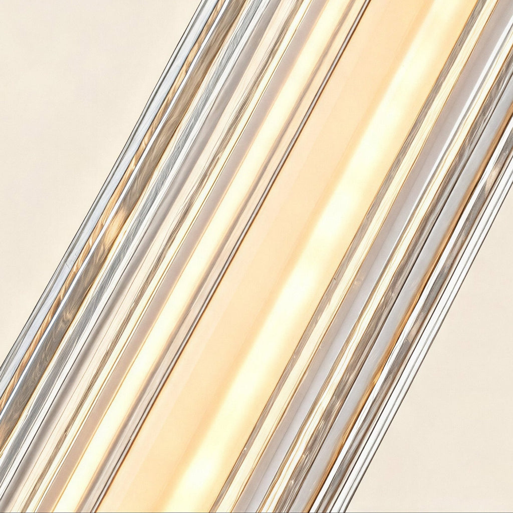 Close-up of fluted clear glass ribs refracting warm LED light along the sconce body, revealing brass accents through the ridged surface
