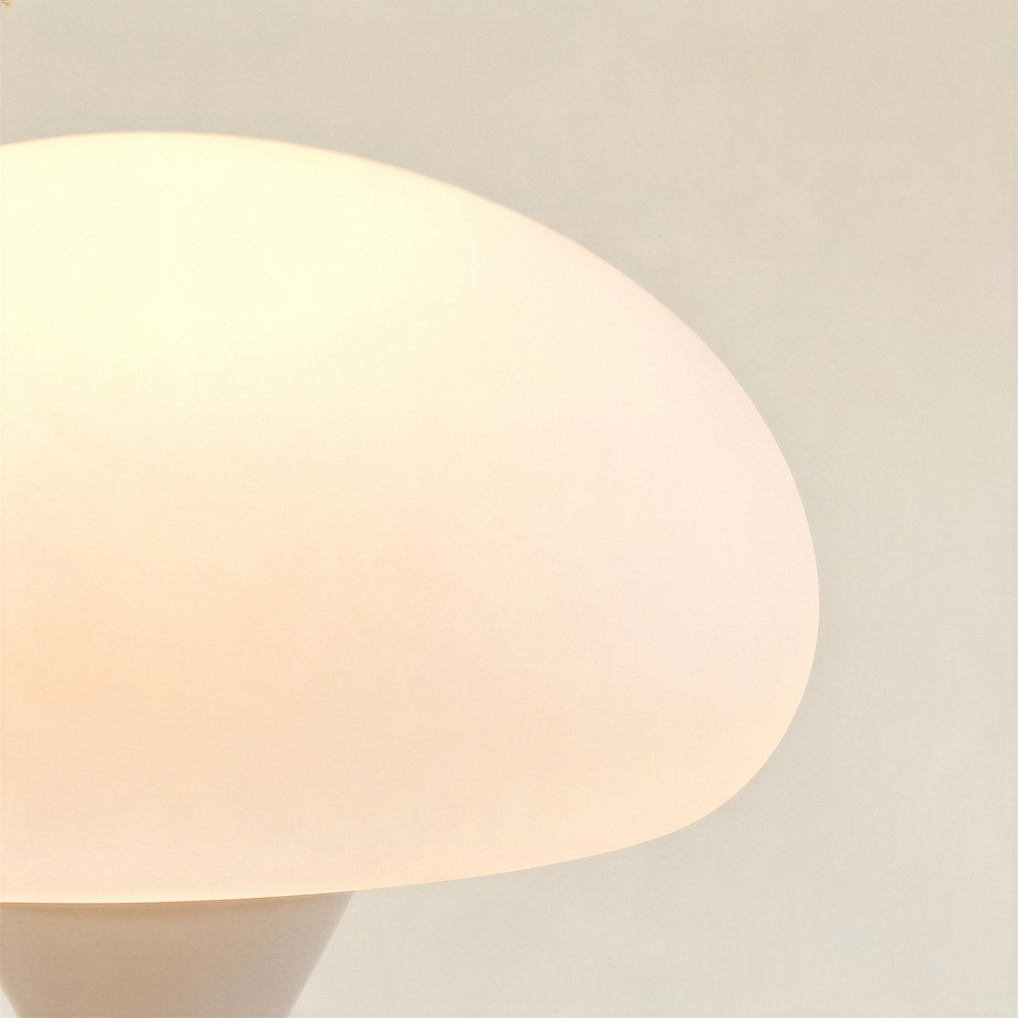 Close-up of the frosted opal glass dome shade, showing soft warm light diffusion and the smooth curved underside edge