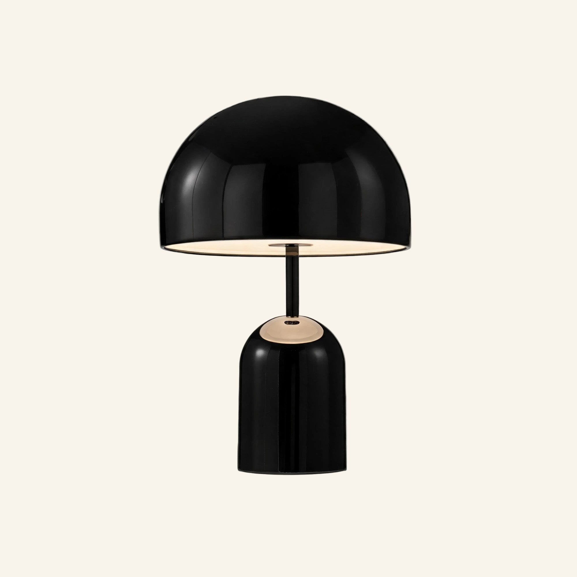 Black gloss version of the dome table lamp on cream background, mirrored shade hovering over a rounded cylindrical metal base