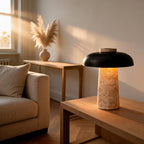 Travertine mushroom lamp lit on an oak coffee table beside a linen sofa, pampas grass on a console in sunlit living room