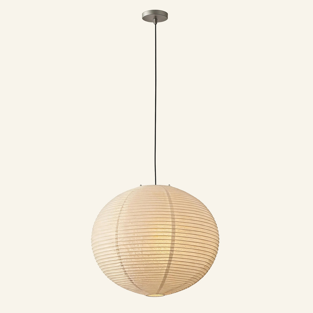 Spherical ribbed cotton rice paper pendant lamp on a long black cord, glowing warmly against a cream background.